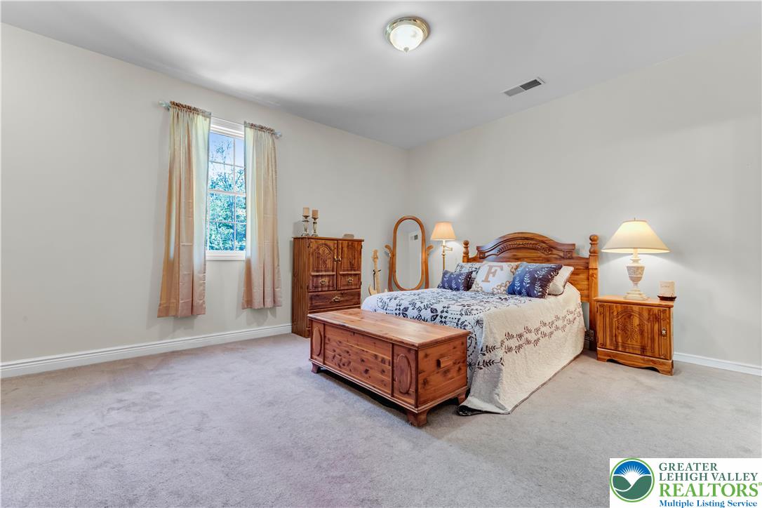 3256 Woodlea Road Orefield, PA 18069 - Photo 38 of 43 a spacious bedroom with a bed and a window