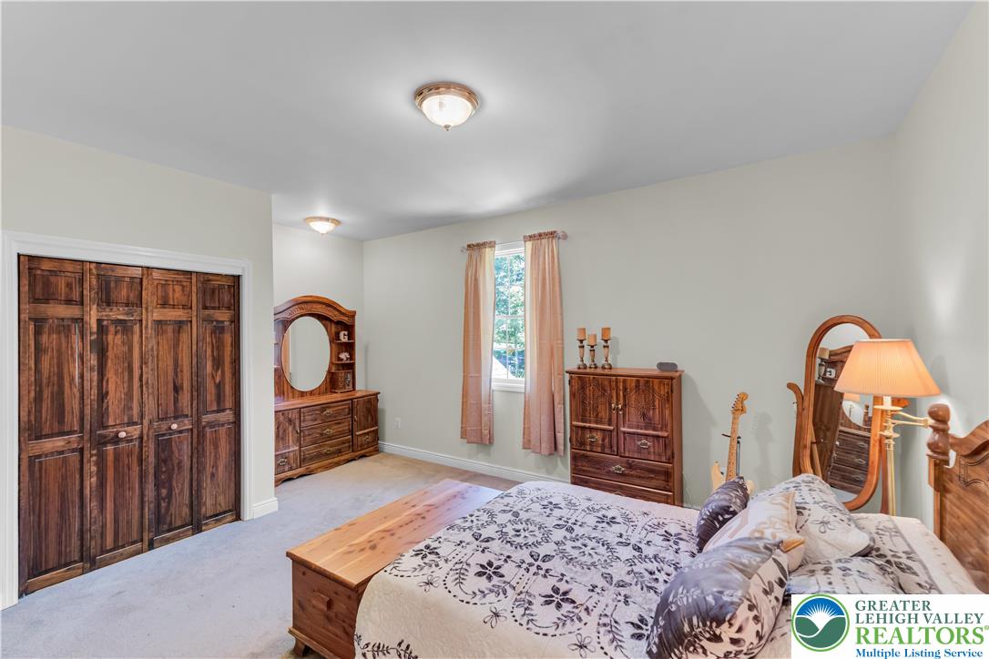 3256 Woodlea Road Orefield, PA 18069 - Photo 39 of 43 a bedroom with a bed and a dresser