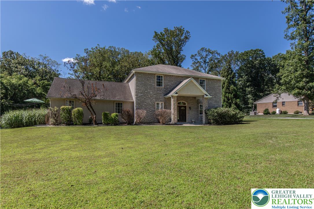 3256 Woodlea Road Orefield, PA 18069 - Photo 4 of 43 a front view of a house with a garden