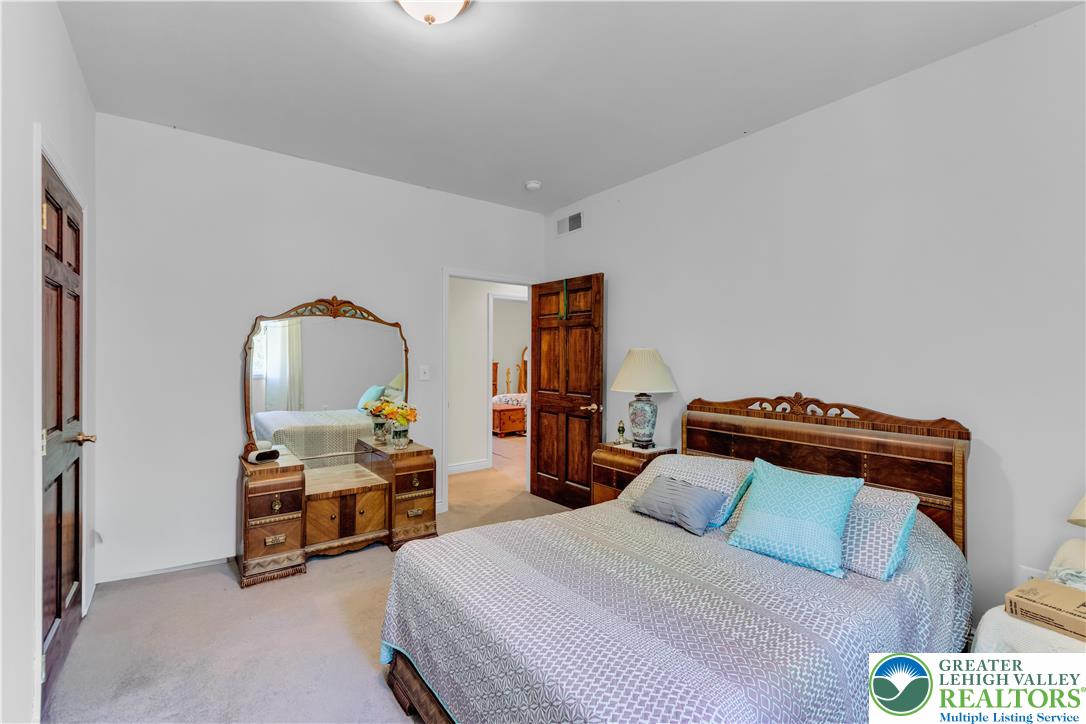 3256 Woodlea Road Orefield, PA 18069 - Photo 41 of 43 a bedroom with furniture and a lamp