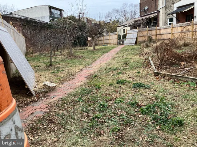 a view of house with a yard