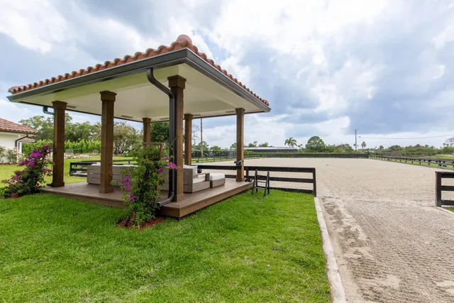 a view of a house with a yard and a patio