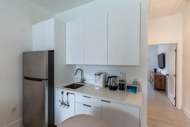 a kitchen with stainless steel appliances a refrigerator sink and cabinets