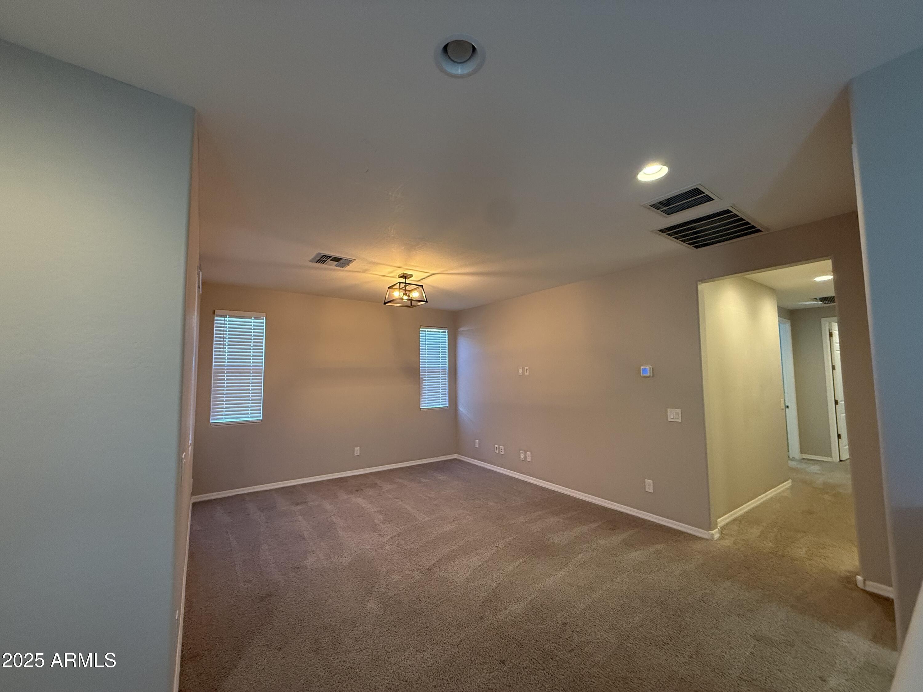 3786 East Robert Street Gilbert, AZ 85295 - Photo 11 of 22 an empty room with chandelier fan and windows