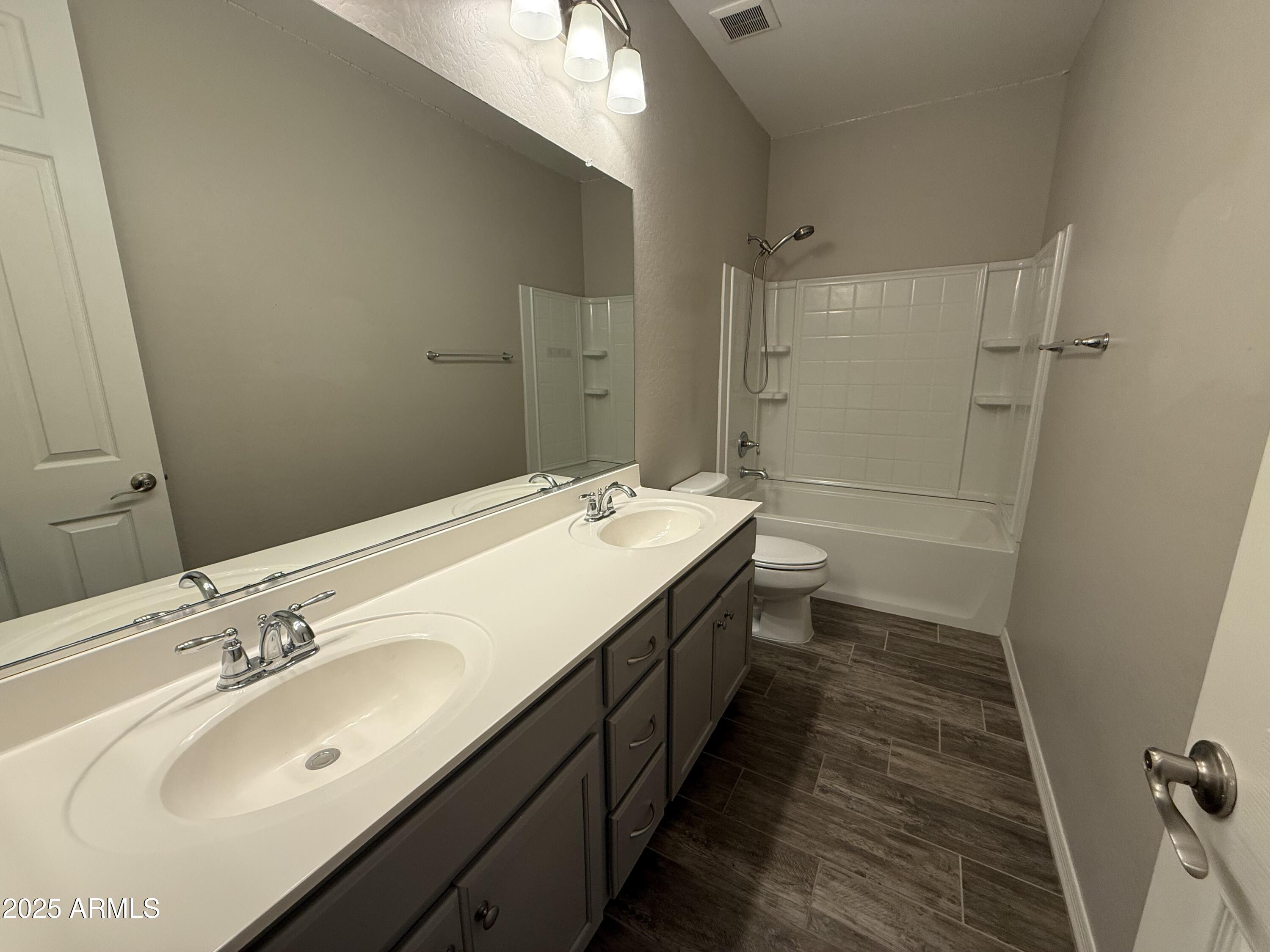 3786 East Robert Street Gilbert, AZ 85295 - Photo 14 of 22 a bathroom with a double vanity sink and mirror with shower