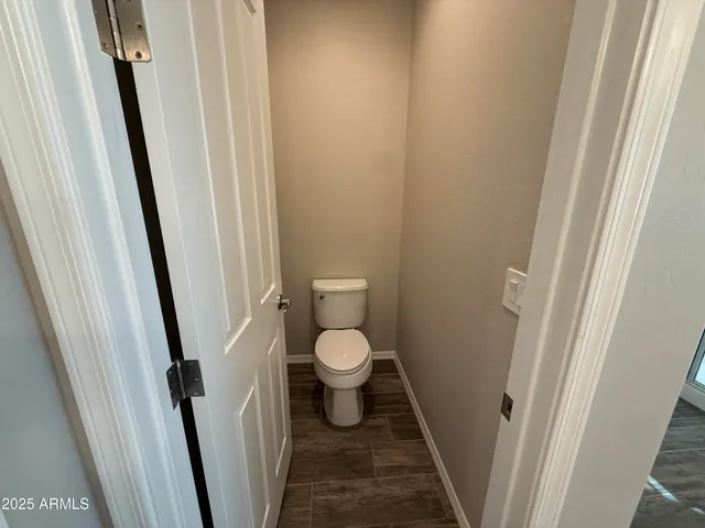 a bathroom with a granite countertop toilet and a sink