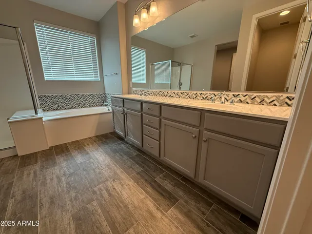 a spacious bathroom with a bathtub and a sink