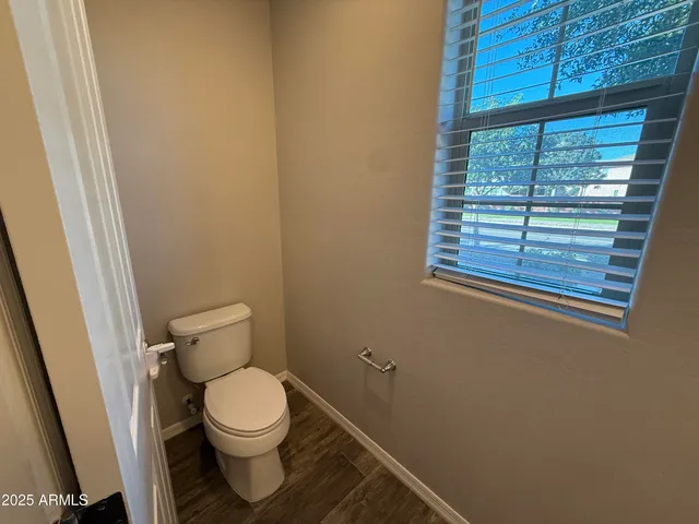 a white toilet sitting next to a window
