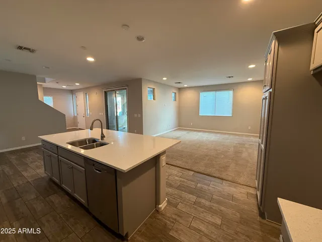 a kitchen with kitchen island a sink stove and a refrigerator