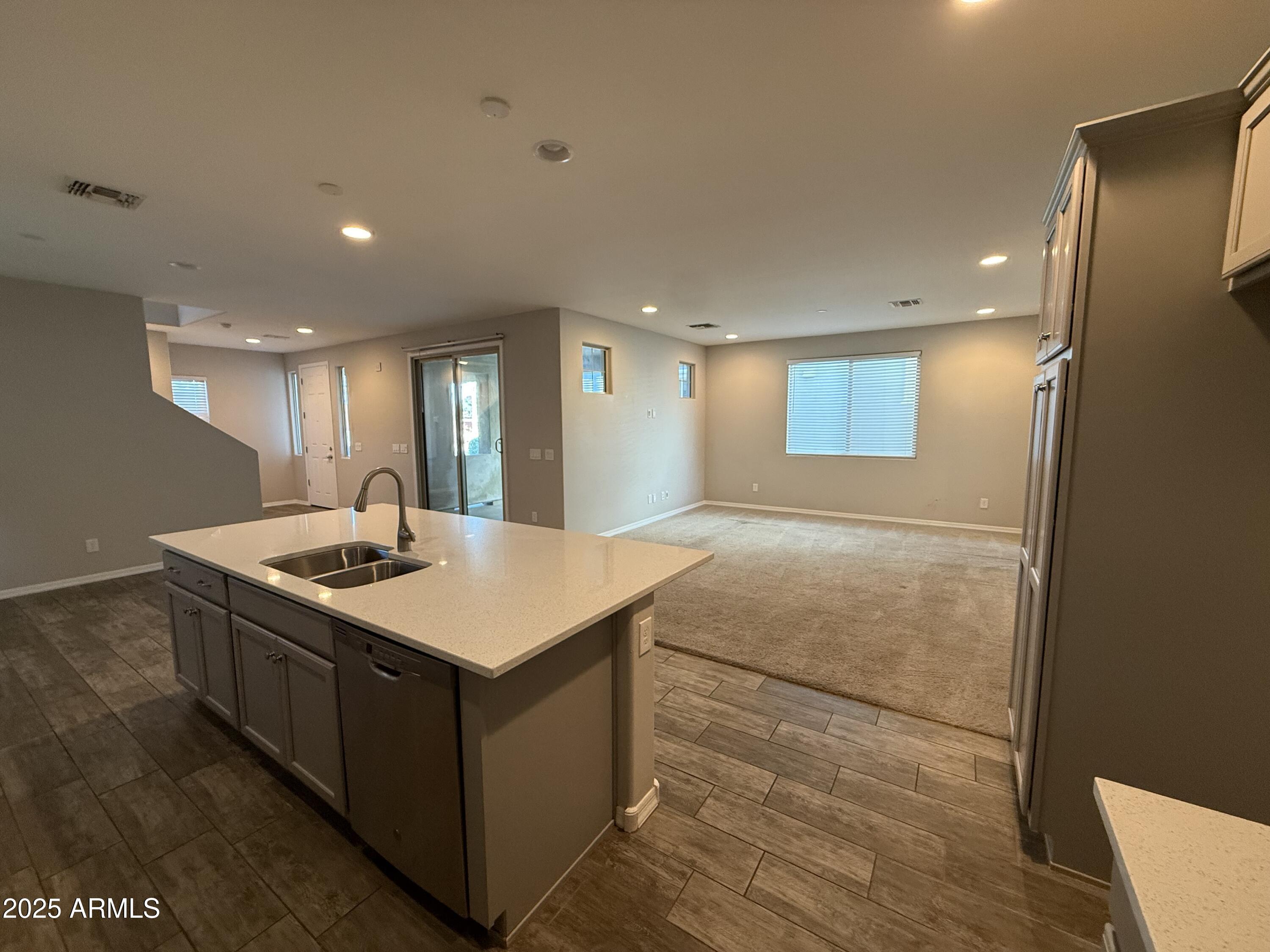 3786 East Robert Street Gilbert, AZ 85295 - Photo 7 of 22 a kitchen with kitchen island a sink stove and a refrigerator