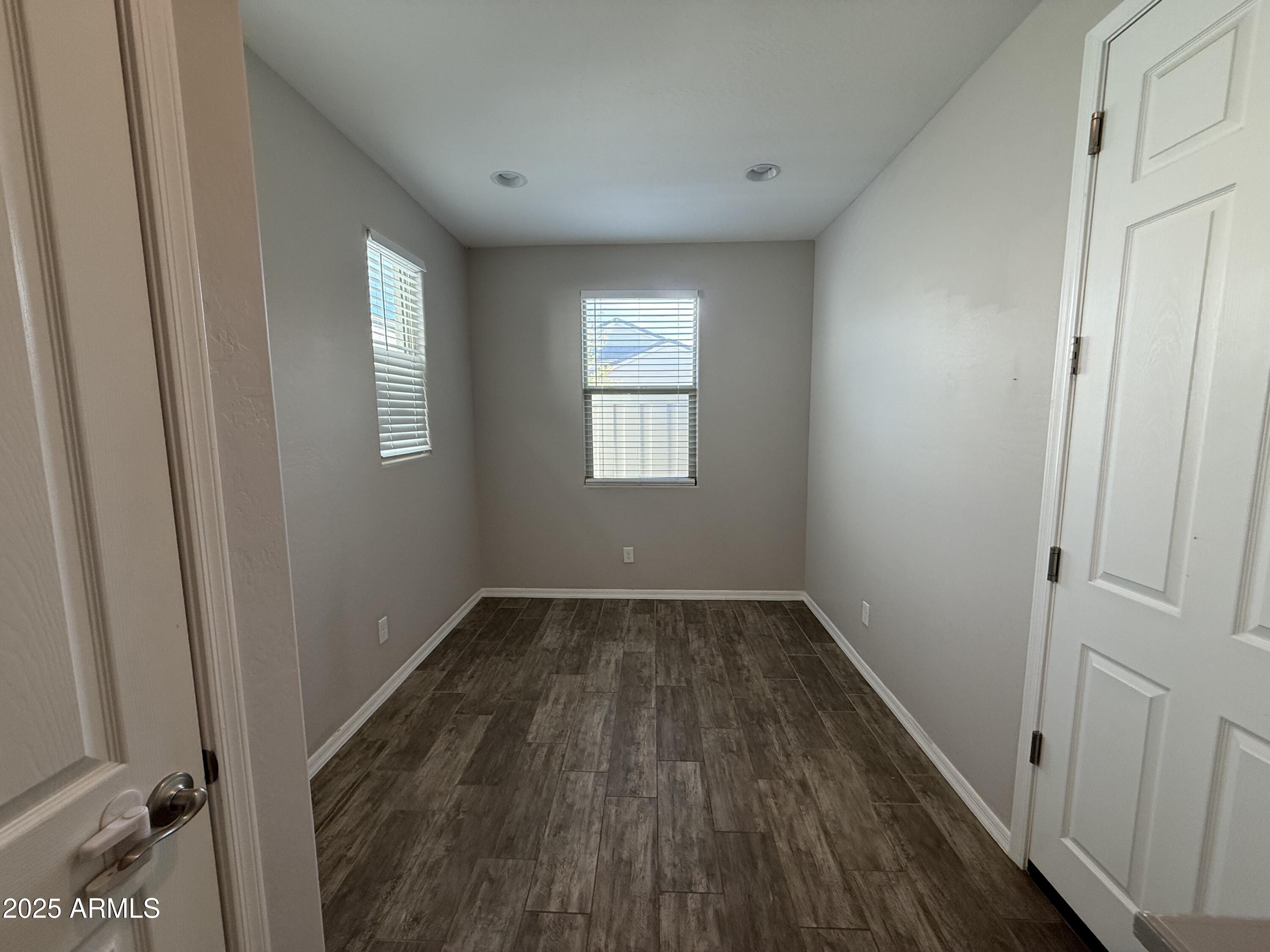 3786 East Robert Street Gilbert, AZ 85295 - Photo 9 of 22 a view of an empty room with wooden floor and a window