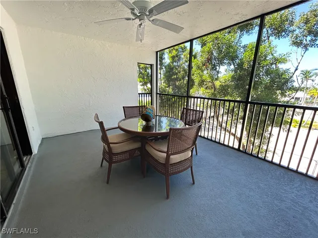 a dining room with furniture a rug and a large window