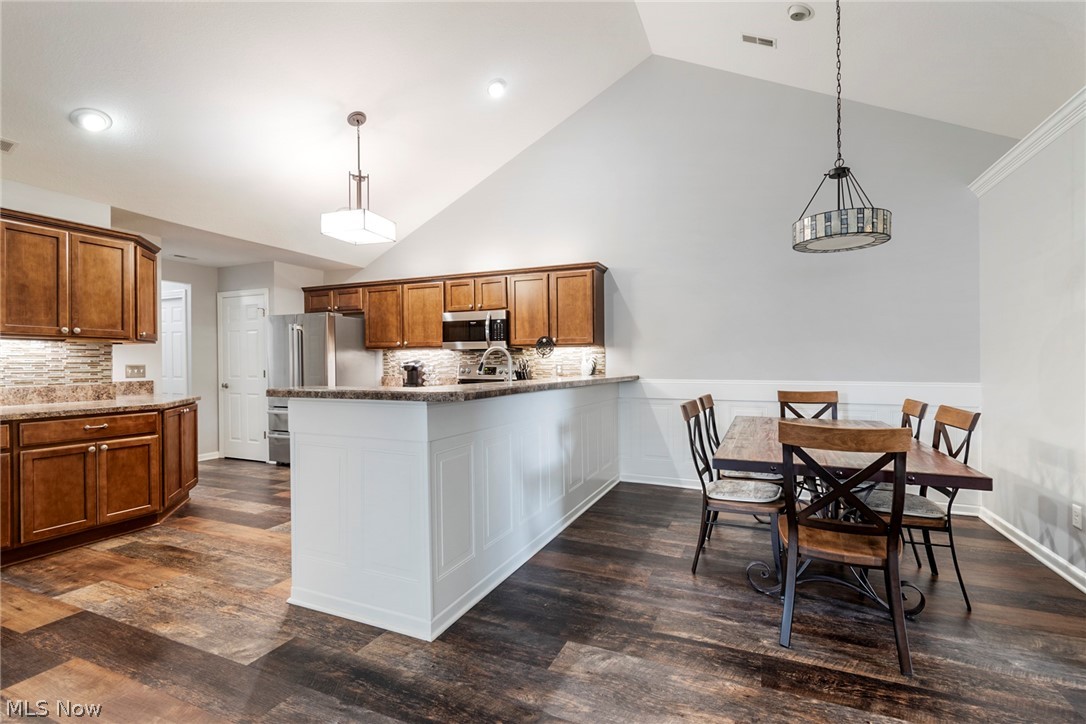 9151 Springfield Road, Unit 1902 Youngstown, OH 44514 - Photo 11 of 36 Kitchen with stainless steel appliances, dark wood-type flooring, and tasteful backsplash