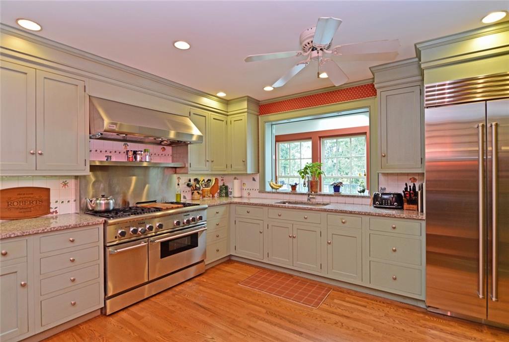 407 Rhodora Lane Pittsburgh, PA 15238 - Photo 16 of 48 a kitchen with stainless steel appliances granite countertop a stove a sink and white cabinets with wooden floor