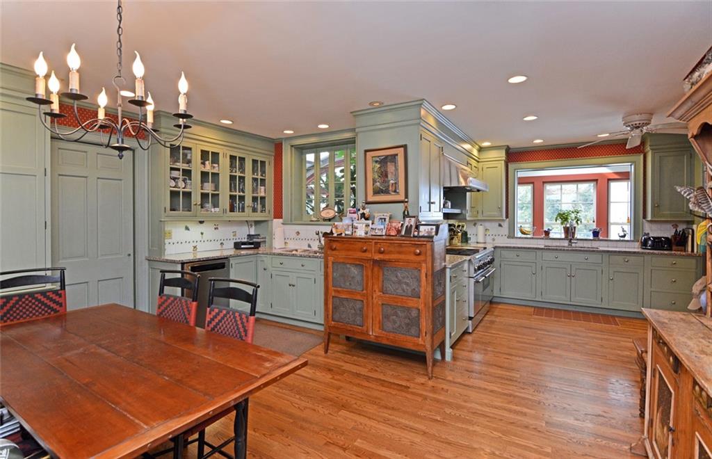 407 Rhodora Lane Pittsburgh, PA 15238 - Photo 17 of 48 a kitchen with stainless steel appliances kitchen island granite countertop a stove a sink dishwasher and a dining table with cabinets