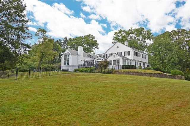a bedroom with a bed dresser and window