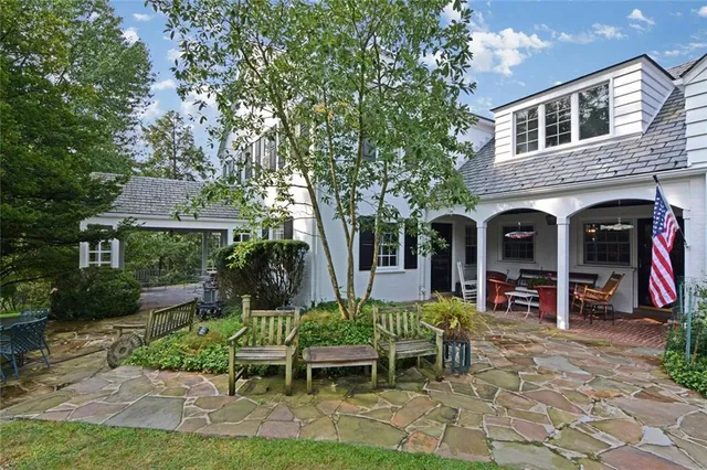a view of a chairs and table in backyard of the house