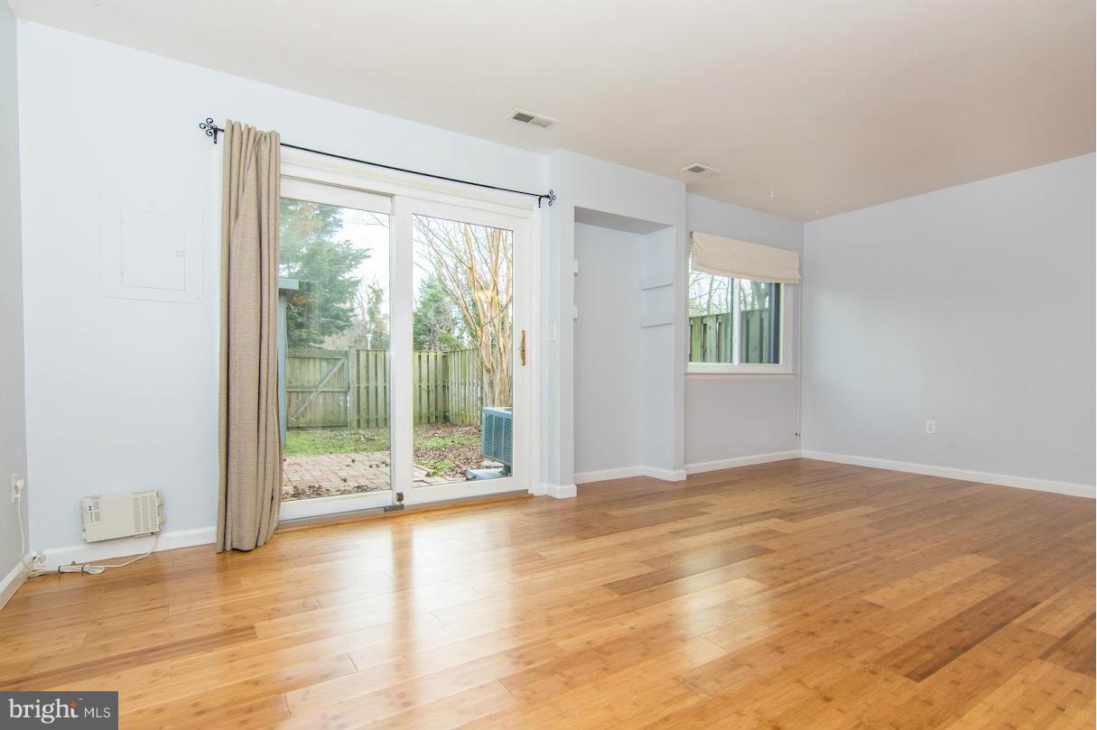 1017 Cedar Ridge Court Annapolis, MD 21403 - Photo 3 of 20 a view of an empty room with wooden floor and a window