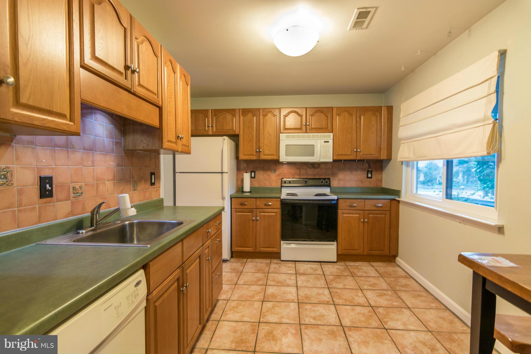 1017 Cedar Ridge Court Annapolis, MD 21403 - Photo 9 of 20 a kitchen with a sink a stove cabinets and counter space