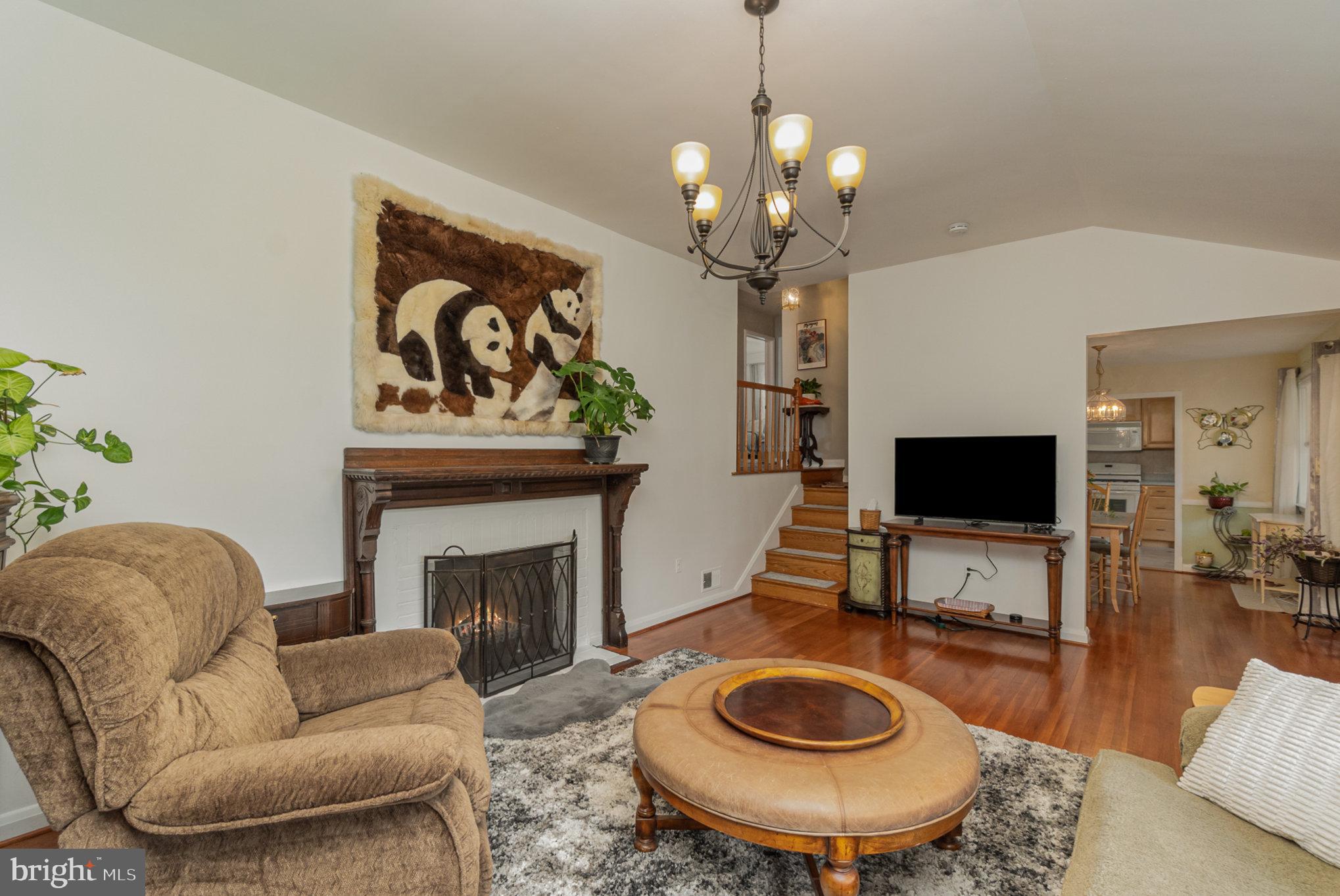 1406 Shefford Road Baltimore, MD 21239 - Photo 12 of 33 a living room with furniture a fireplace and a flat screen tv