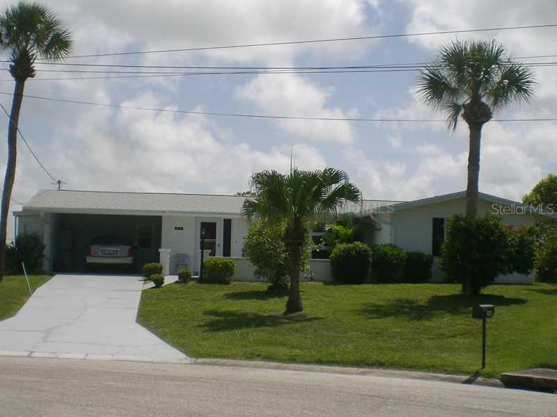 512 Hazelwood Road Venice, FL 34293 - Photo 1 of 1 Exterior Front - Nicely landscaped pie shaped lot measures 135 feet across the back which is the lakefront and 128 feet on each wside and 47 feet across the front.