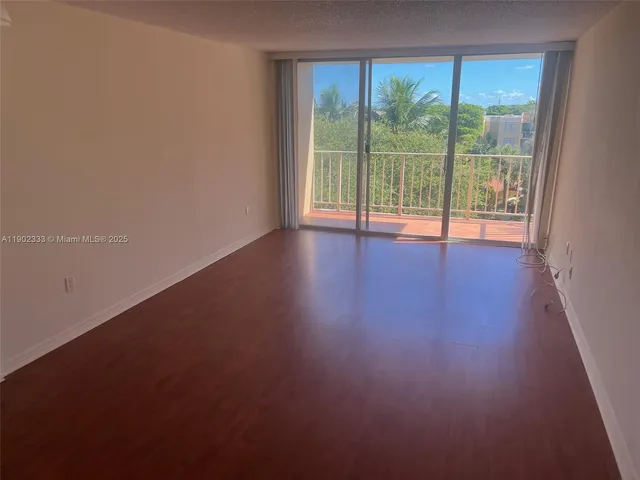 a view of room with window and wooden floor