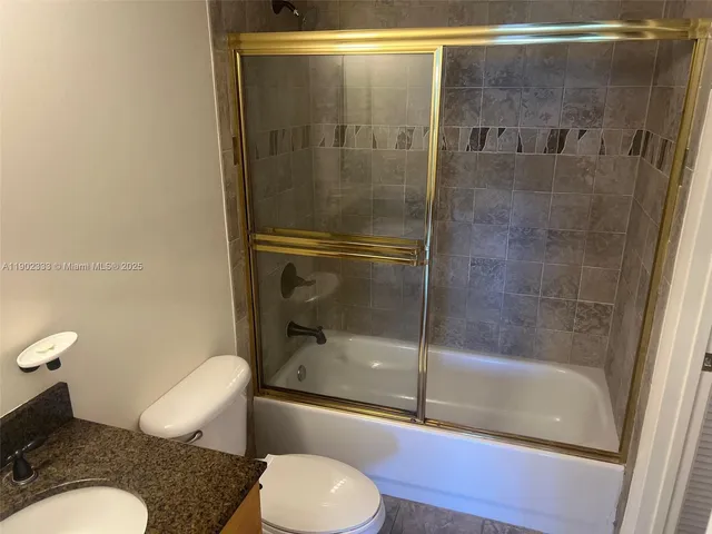 a bathroom with a shower and toilet
