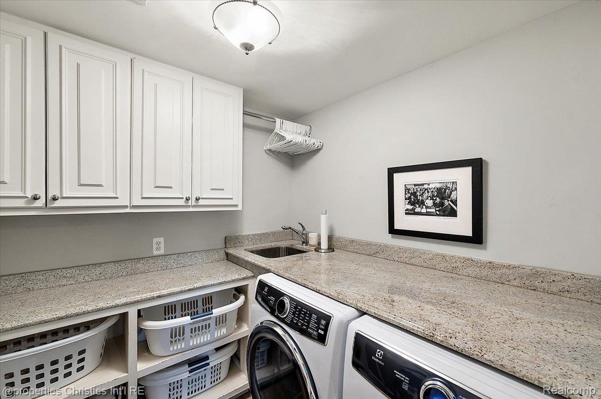 135 Clifton Road Bloomfield Hills, MI 48301 - Photo 57 of 77 Laundry room featuring white shaker-style cabinetry, a built-in utility sink, stone countertops, and a clothes hanging rod