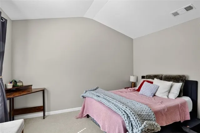 a bedroom with a bed and a dresser in it