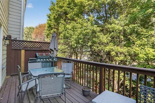 a view of balcony with wooden floor and outdoor seating