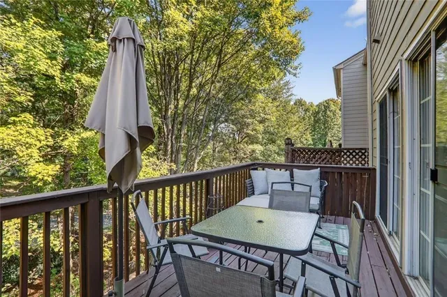 a view of a balcony with a table and chairs