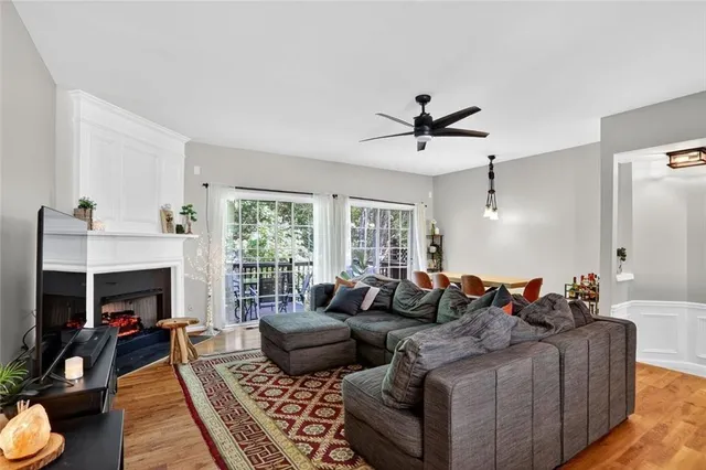 a living room with furniture ceiling fan and a fireplace