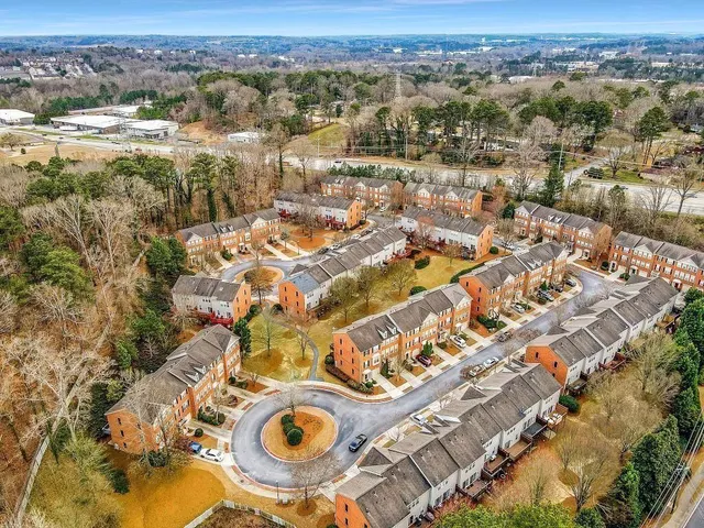 an aerial view of residential houses with outdoor space
