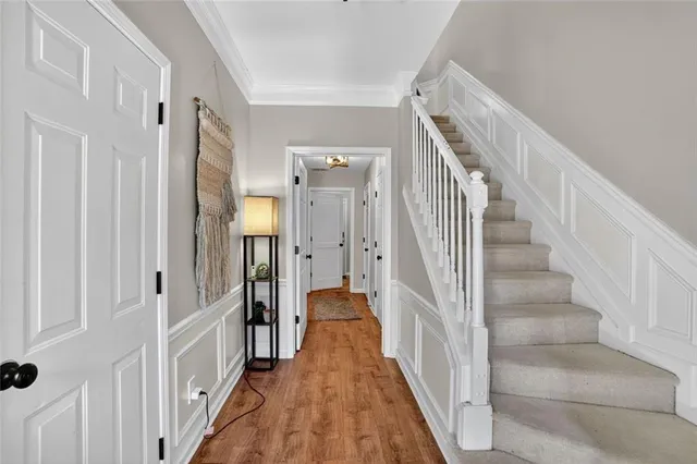 a view of a hallway with a white walls and stairs