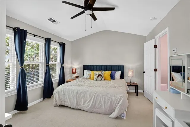 a bedroom with a bed and a flat tv screen