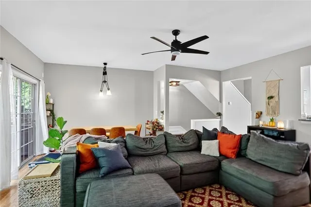 a living room with furniture a rug and a window