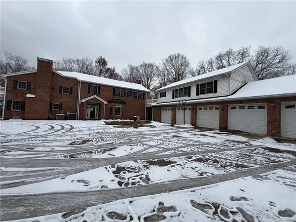 a view of a house with a snow in the yard