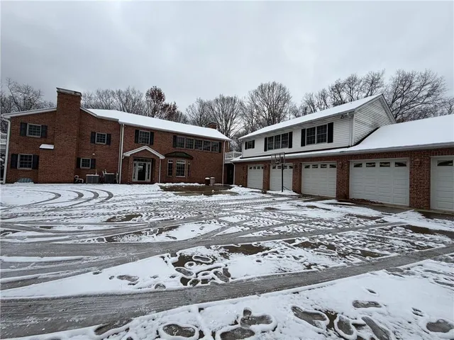 a view of a house with a snow in the yard