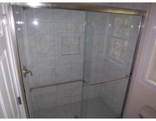 38 Standish Road Arlington, MA 02478 - Photo 16 of 24 a bathroom with a glass shower door