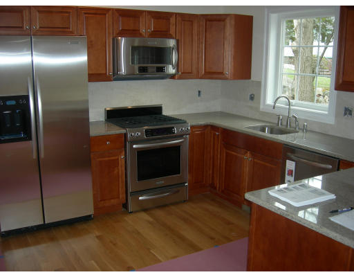 38 Standish Road Arlington, MA 02478 - Photo 2 of 24 a kitchen with stainless steel appliances granite countertop a sink a stove a refrigerator and cabinets