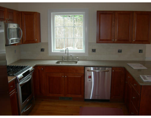 38 Standish Road Arlington, MA 02478 - Photo 3 of 24 a kitchen with granite countertop a stove a sink and a microwave