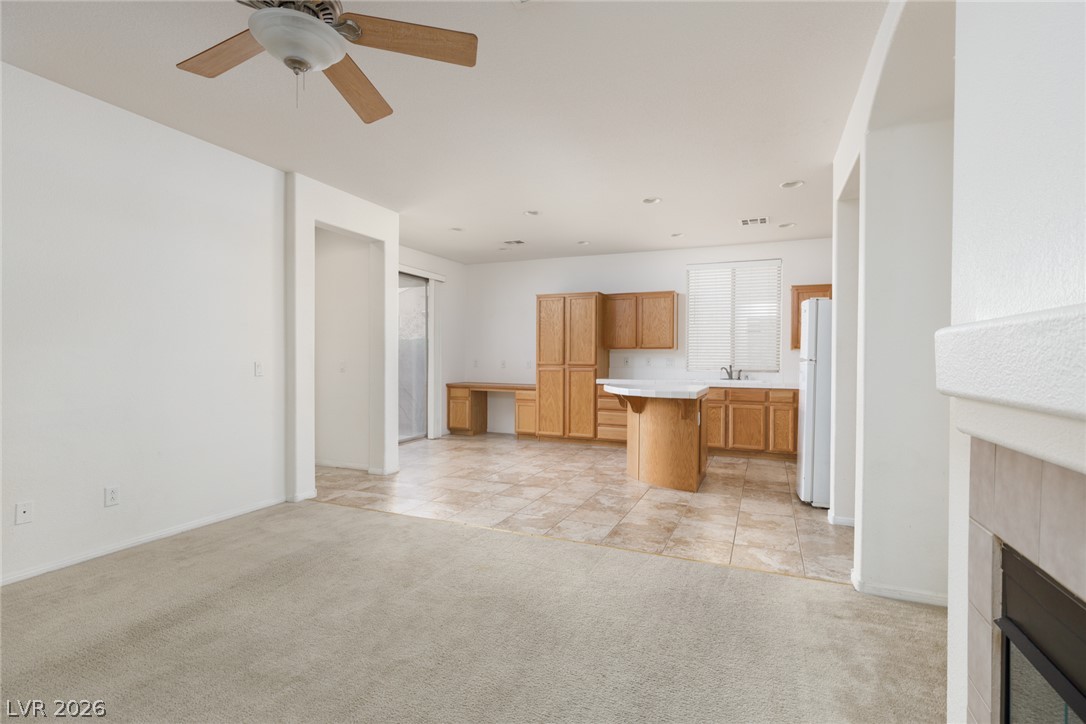 787 Rise Canyon Drive Henderson, NV 89052 - Photo 22 of 22 An open floorplan seamlessly connects the living area to a kitchen featuring a convenient island.
