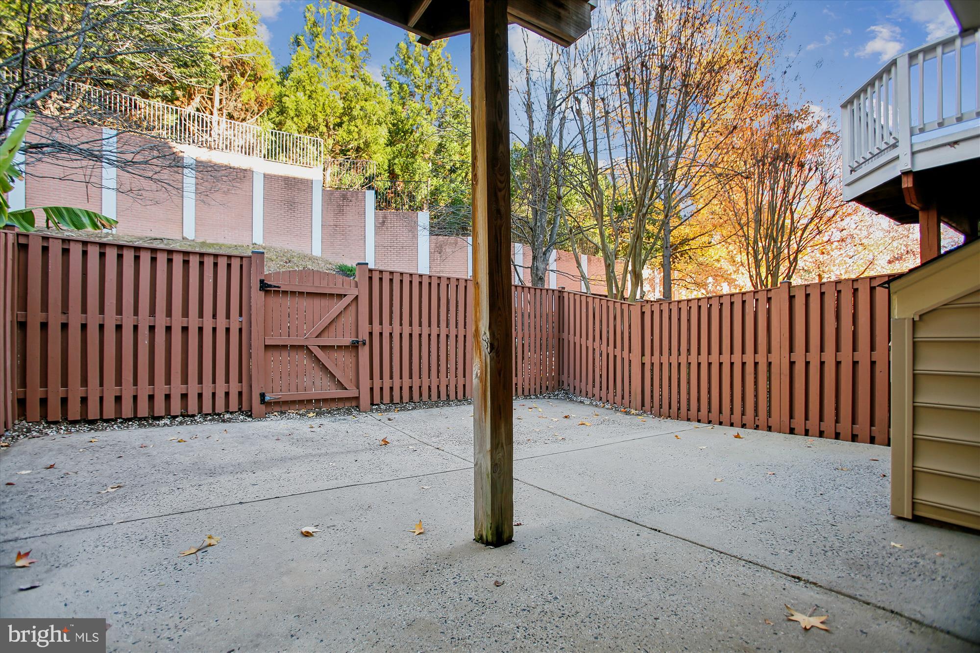 5450 Edsall Ridge Place Alexandria, VA 22312 - Photo 60 of 85 a view of a brick house with a large window and wooden fence