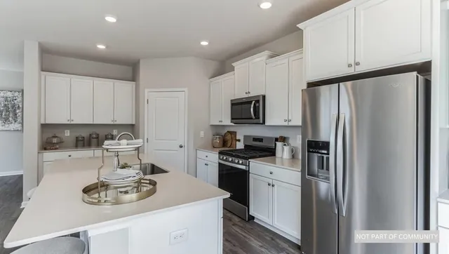 a kitchen with a table chairs stove and glass top table