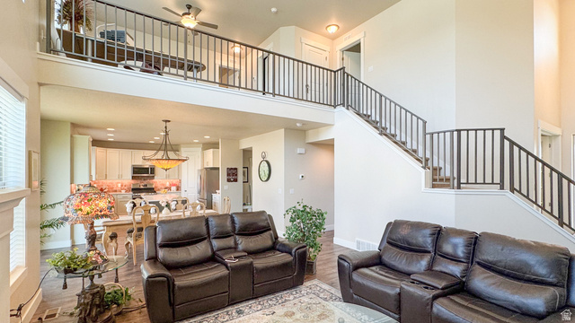 1434 West Stable Street Lindon, UT 84042 - Photo 10 of 76 Living area with a ceiling fan, a high ceiling, wood finished floors, and recessed lighting