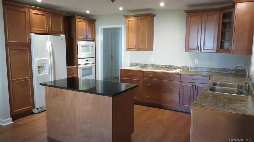 3059 Lake Shore Road South Denver, NC 28037 - Photo 5 of 12 a kitchen with granite countertop a sink a refrigerator and a cabinets