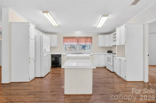 a kitchen with stainless steel appliances a refrigerator a stove top oven and a center island