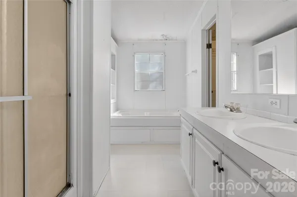 a bathroom with a sink a toilet and a large mirror