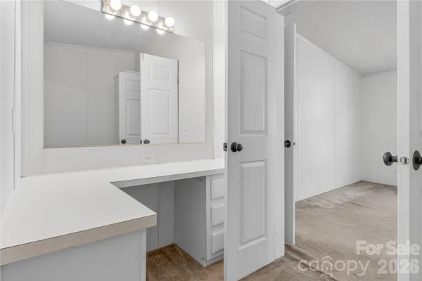 a bathroom with a sink a vanity and a mirror