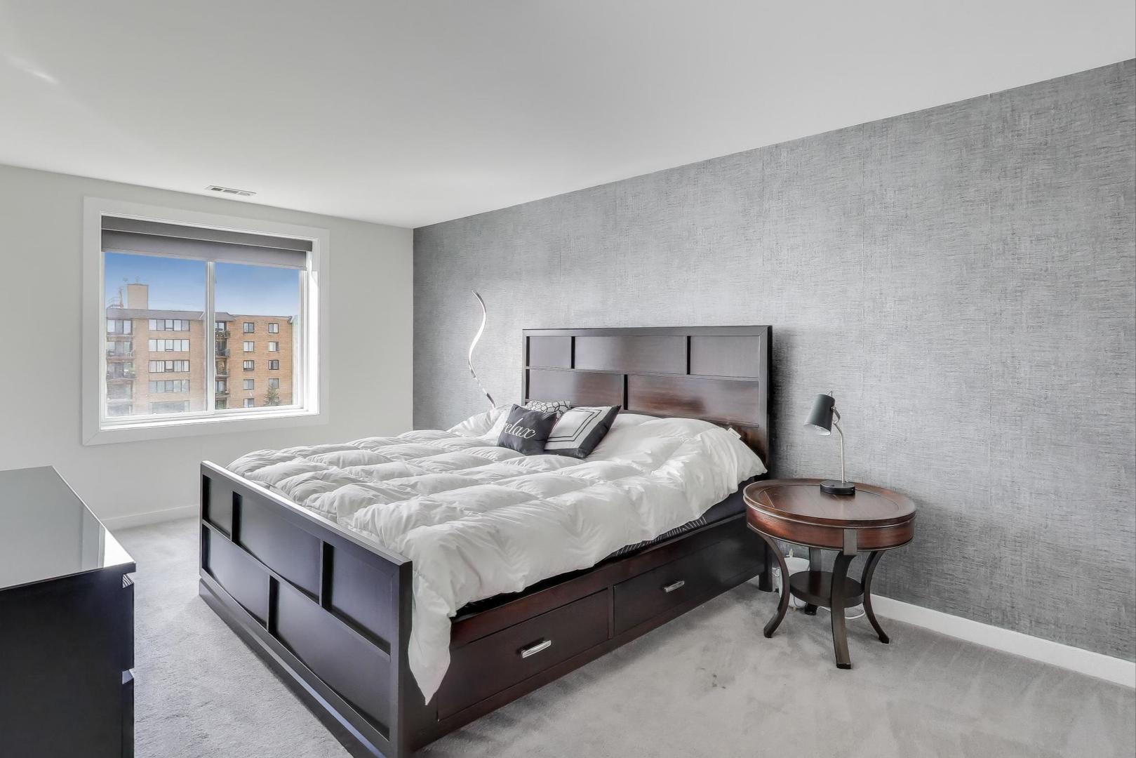 1717 West Crystal Lane, Unit 610 Mount Prospect, IL 60056 - Photo 11 of 23 a bedroom with a bed and a table in it